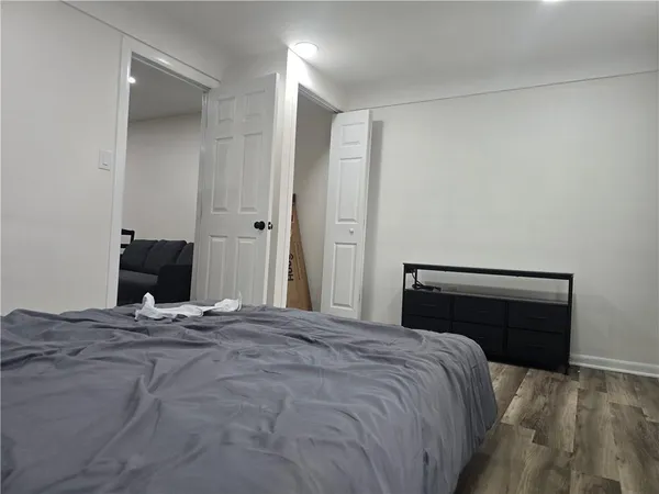 a backyard of a house with large trees and brick walls