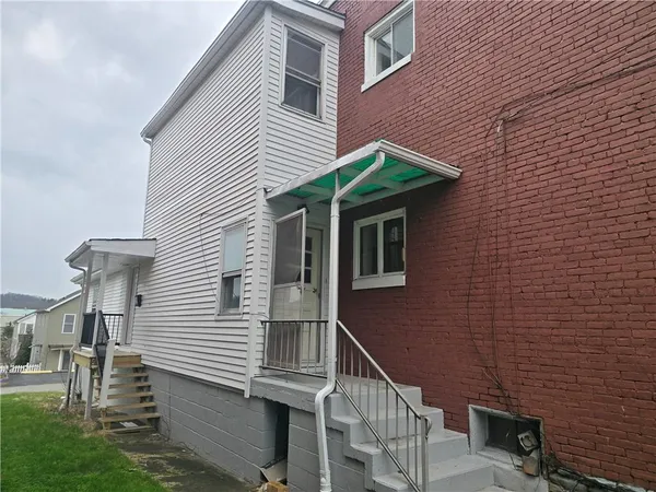 a view of a house with brick walls