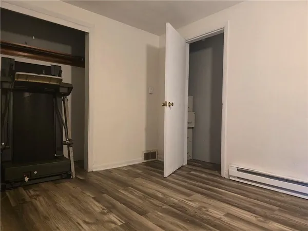 a view of a room with wooden floor and windows