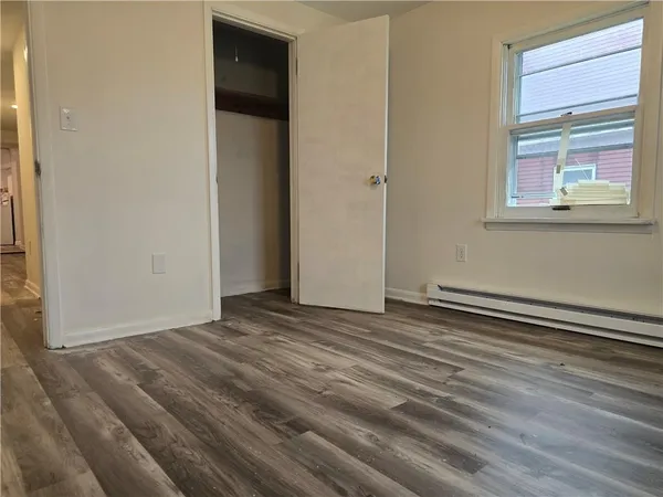 a view of a room with wooden floor
