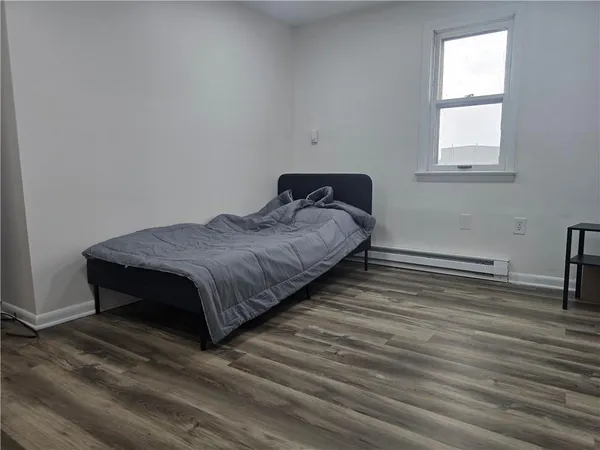 a bed sitting in a bedroom next to a window