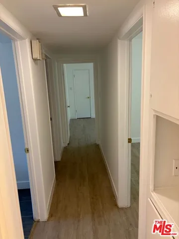 a view of hallway with wooden floor