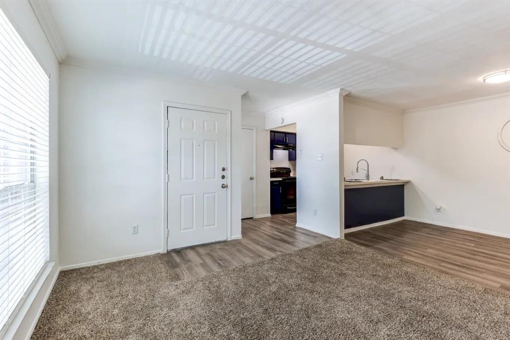 1100 Graham Drive, Unit 702 Tomball, TX 77375 - Photo 1 of 28 an empty room with a window and a kitchen