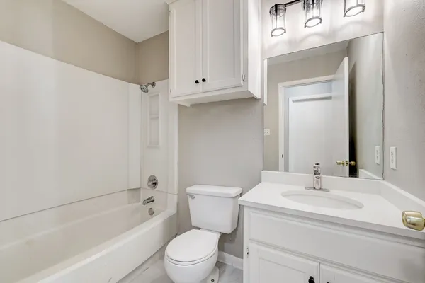 a bathroom with a sink a toilet and a bathtub