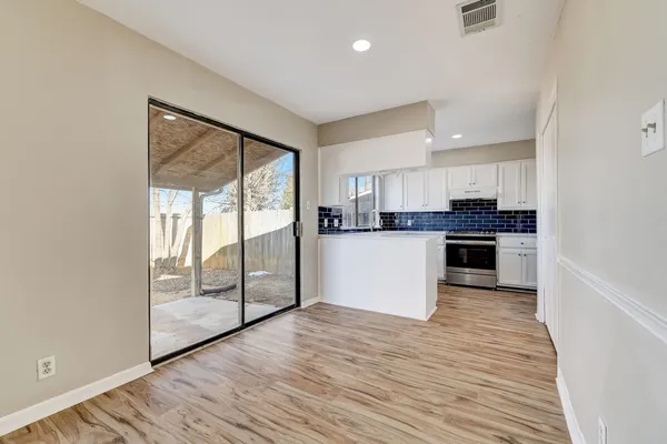 a kitchen with stainless steel appliances granite countertop a stove top oven and a refrigerator