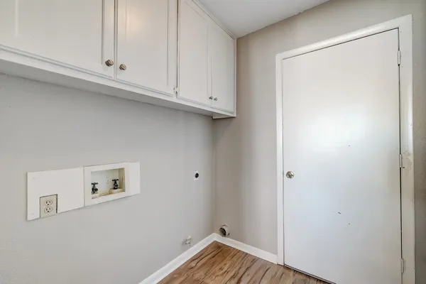 a view of room with hardwood floor and cabinet