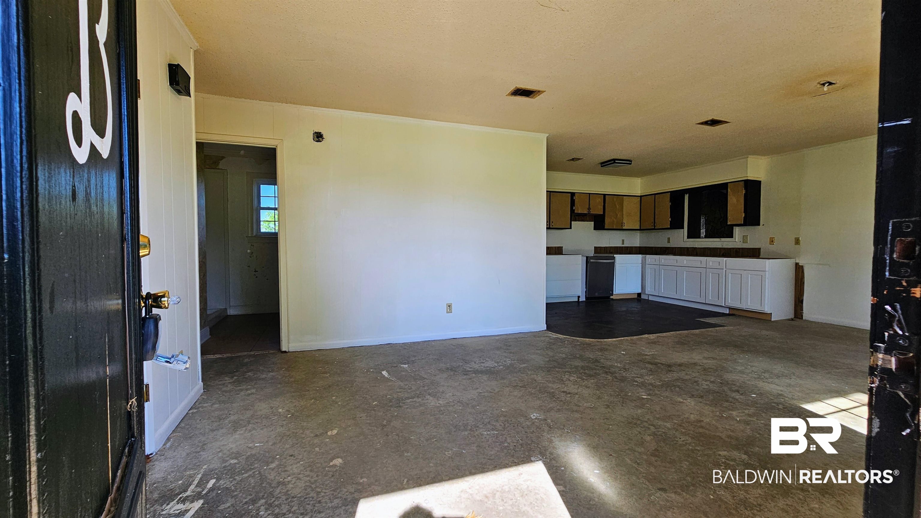 18824 Highway 41 Brewton, AL 36426 - Photo 4 of 40 Open-concept living area with a dark-finish entry door and durable flooring