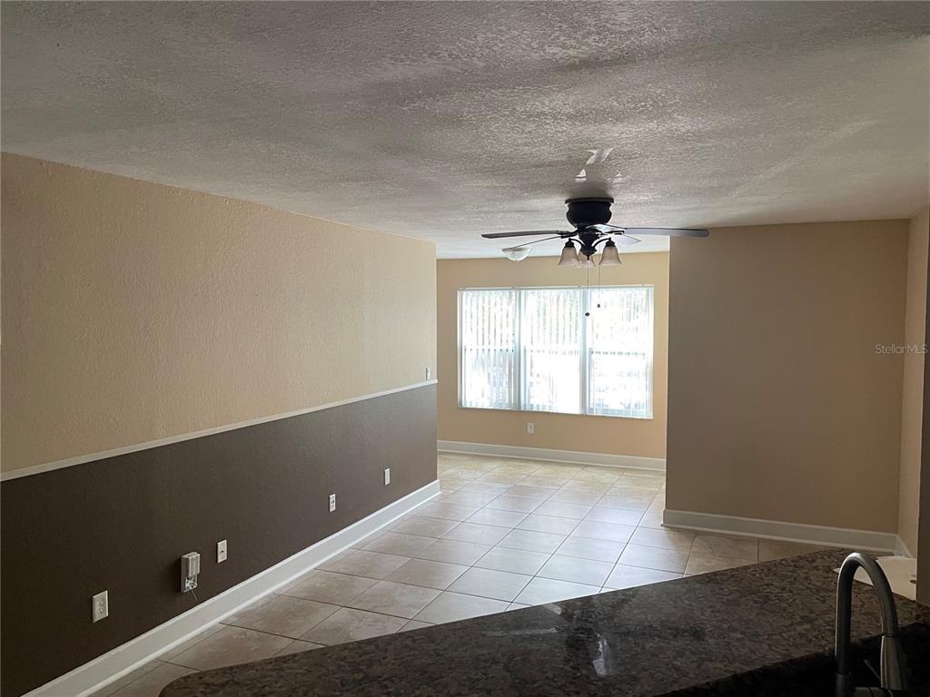 4512 Commander Drive, Unit 1725 Orlando, FL 32822 - Photo 9 of 17 wooden floor in an empty room with a window