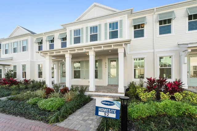 a view of a brick building next to a yard