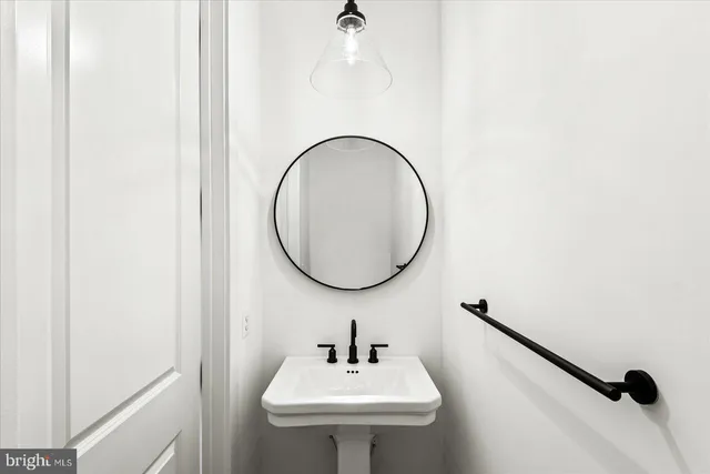 a bathroom with a sink and mirror