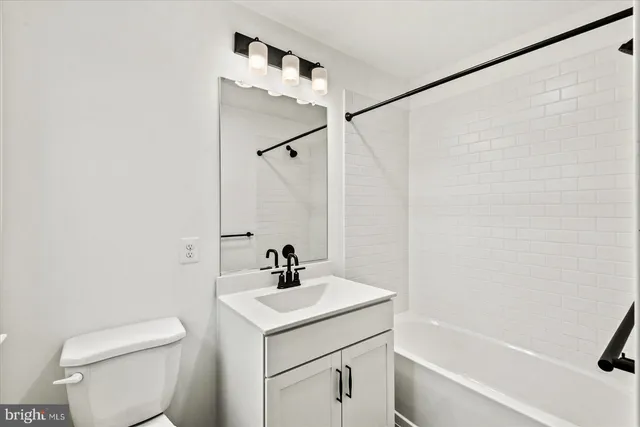 a bathroom with a sink a toilet and a bathtub