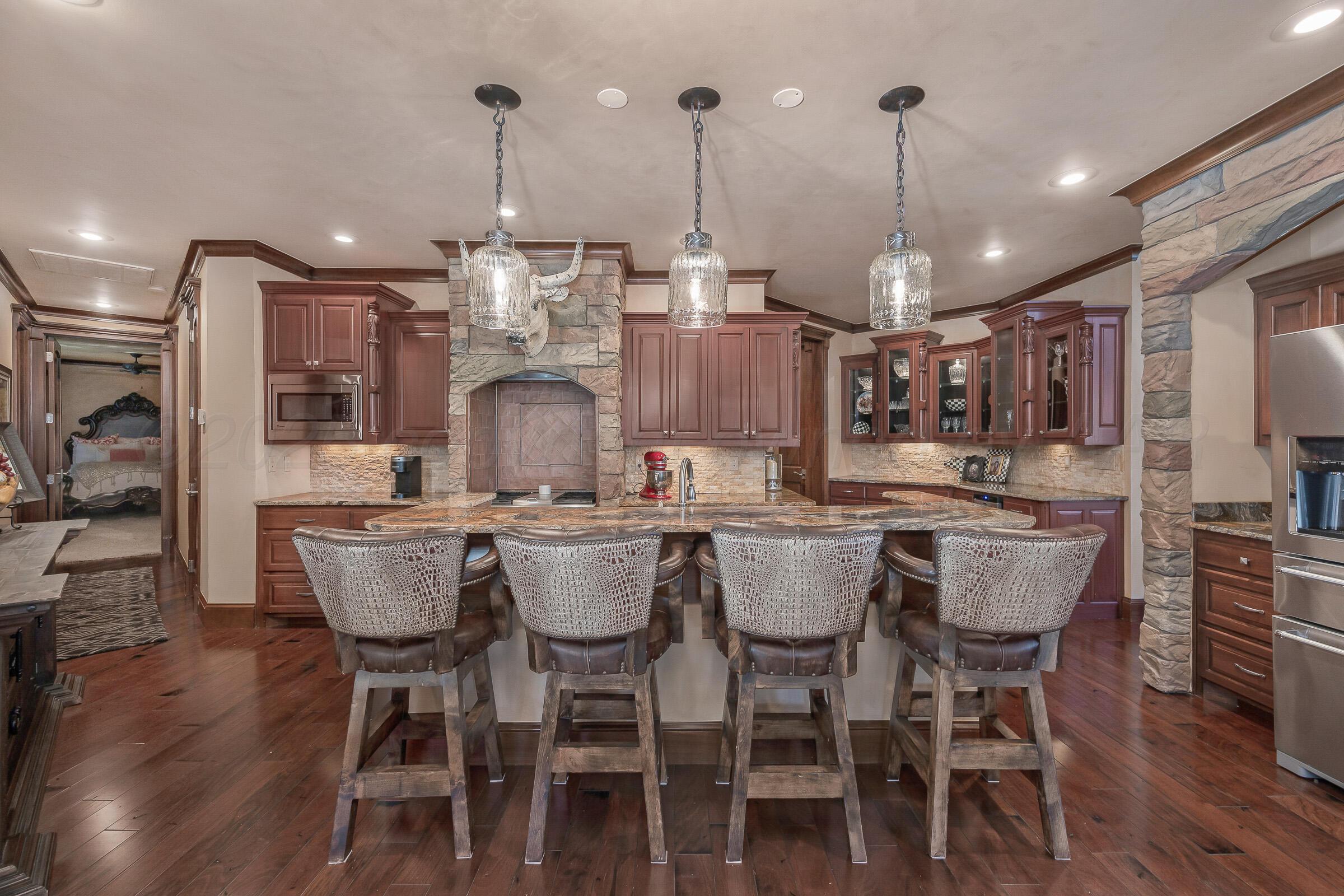 19551 Chaparral Road Canyon, TX 79015 - Photo 12 of 42 a dining table with chairs and kitchen view