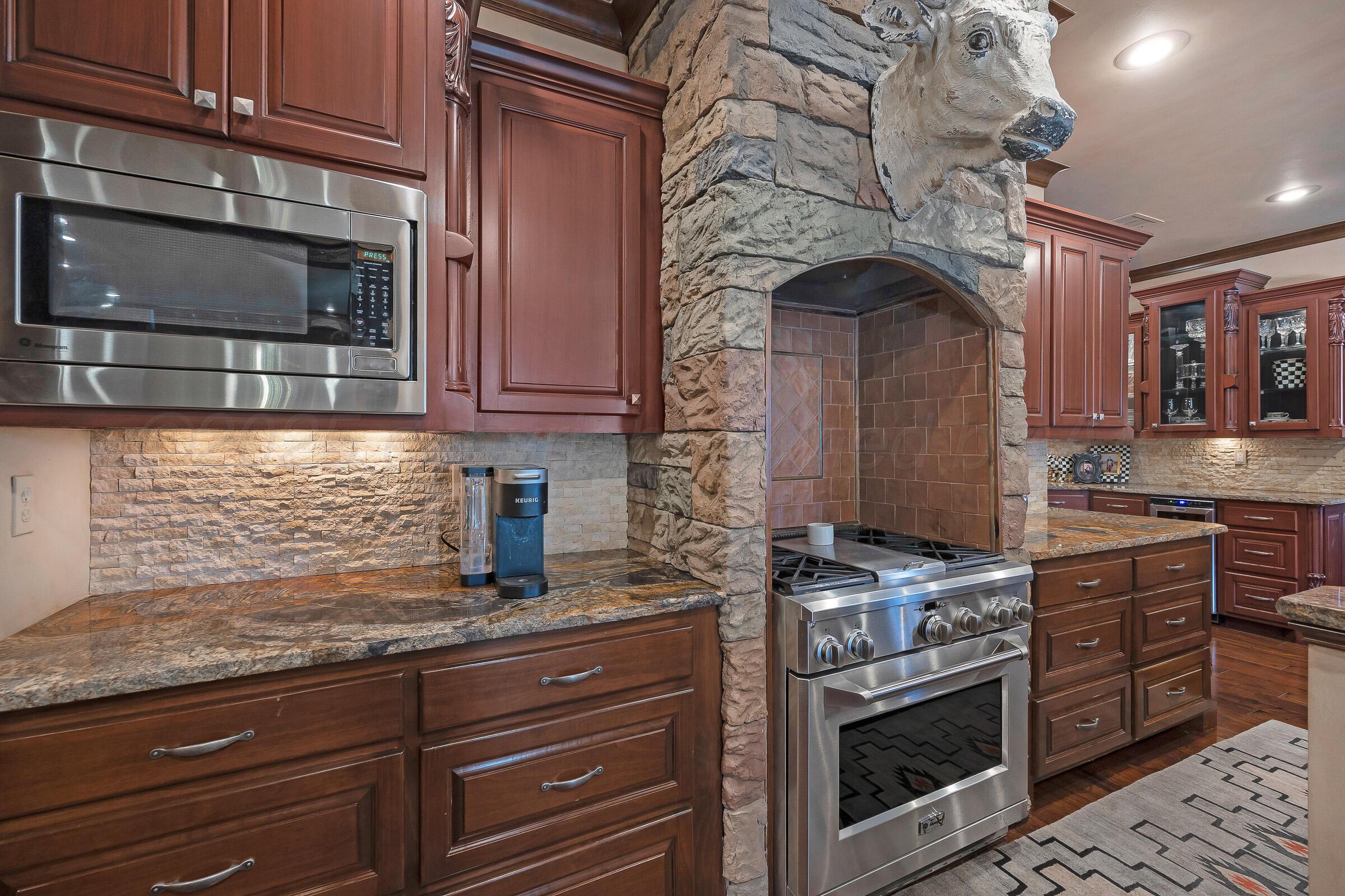 19551 Chaparral Road Canyon, TX 79015 - Photo 13 of 42 a kitchen with stainless steel appliances granite countertop a stove and a microwave