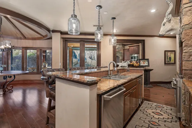a kitchen with a wooden floor and a refrigerator