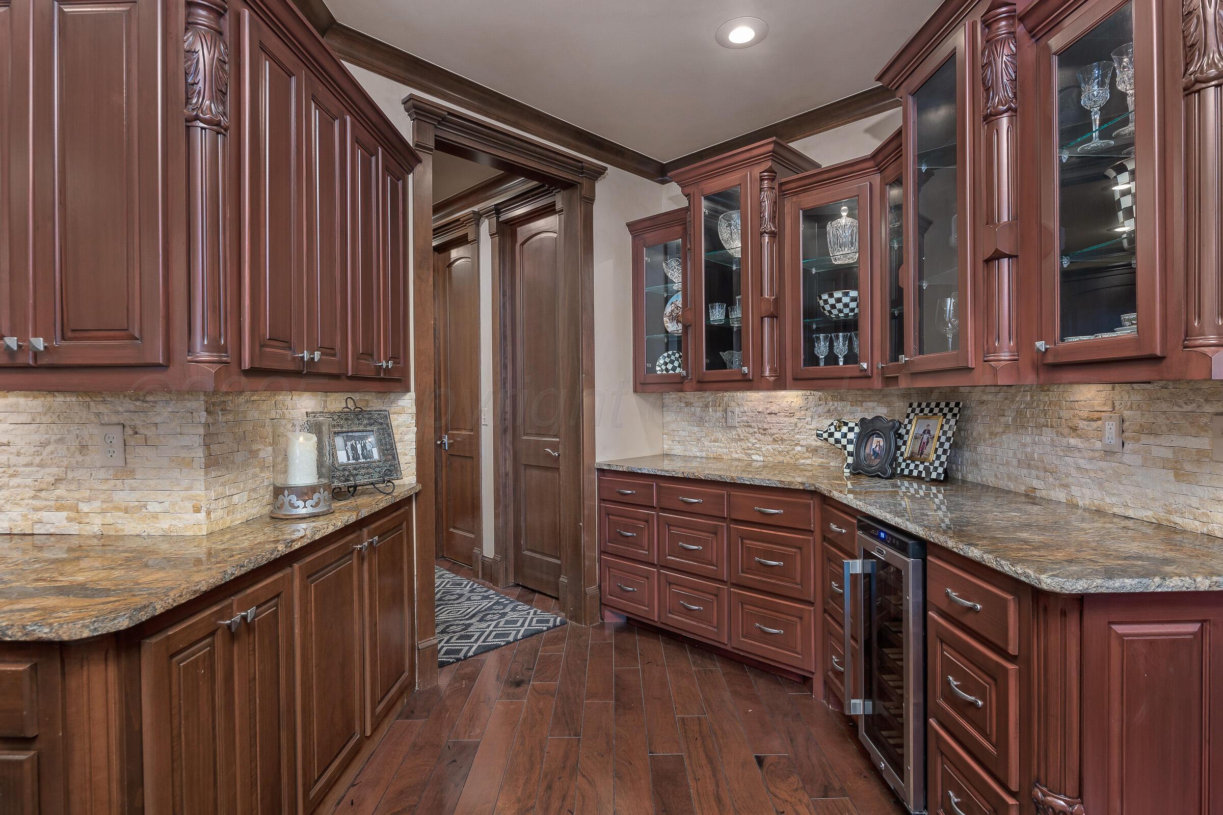 19551 Chaparral Road Canyon, TX 79015 - Photo 16 of 42 a kitchen with stainless steel appliances granite countertop wooden cabinets a refrigerator and dishwasher