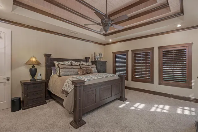 a bedroom with a bed dresser and a flat tv screen