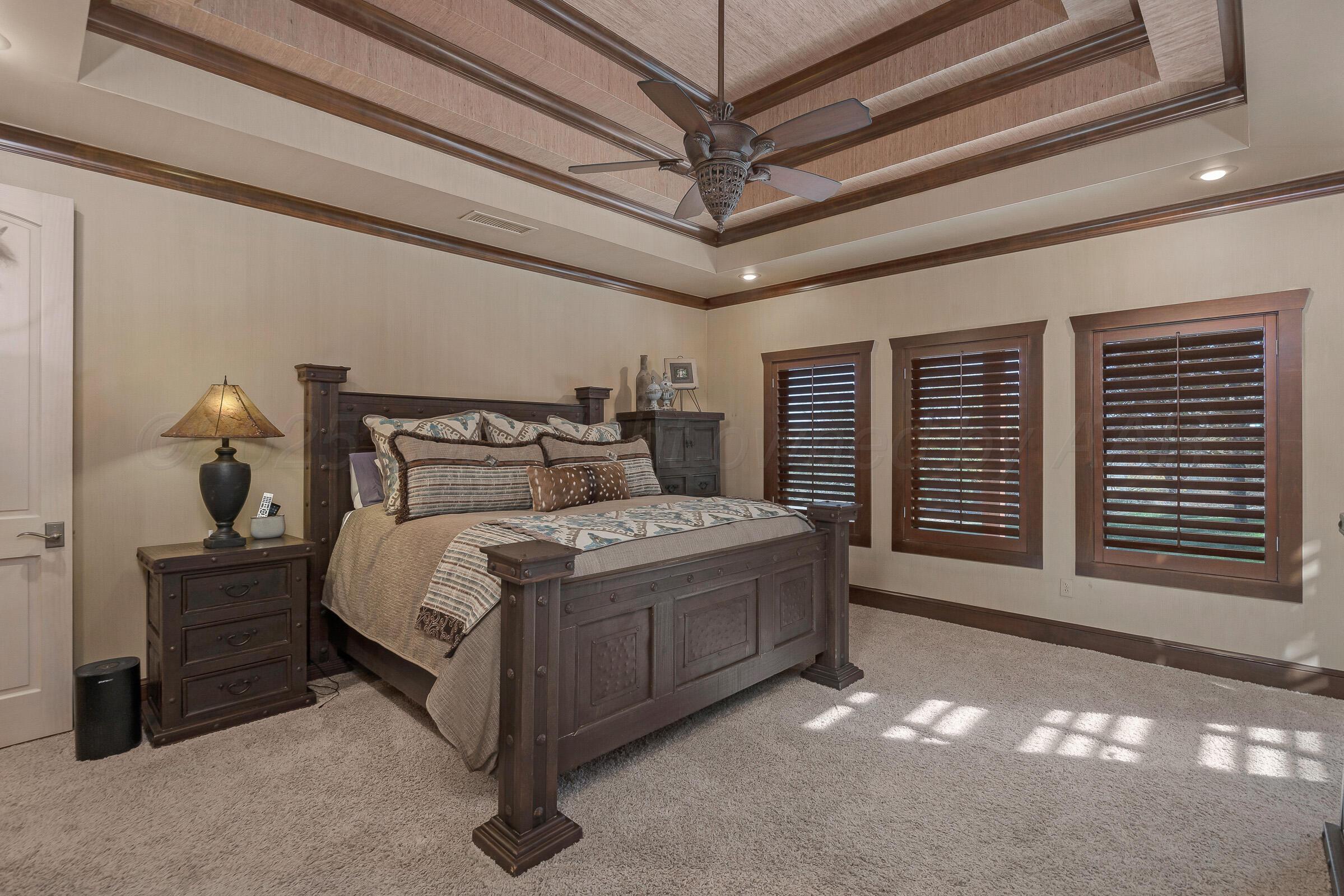 19551 Chaparral Road Canyon, TX 79015 - Photo 18 of 42 a bed sitting in a spacious bedroom next to a window
