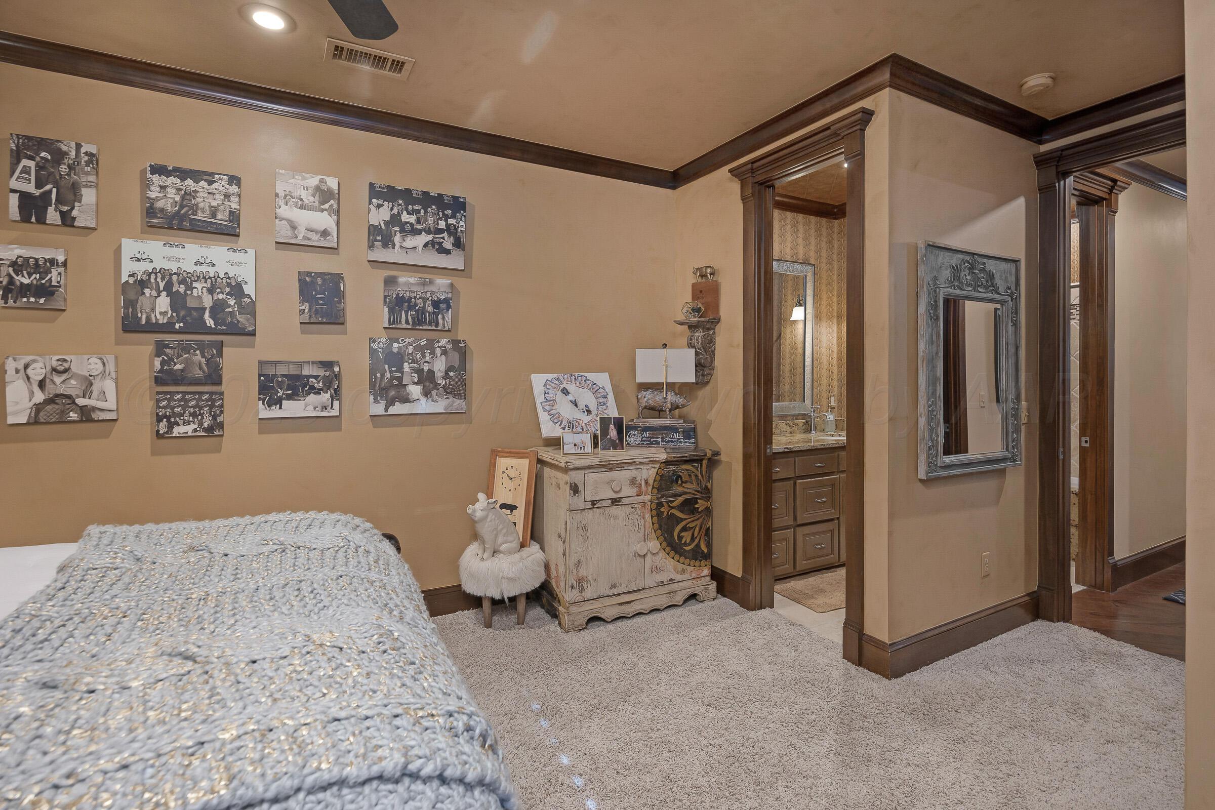 19551 Chaparral Road Canyon, TX 79015 - Photo 26 of 42 a spacious bedroom with a bed and cabinets