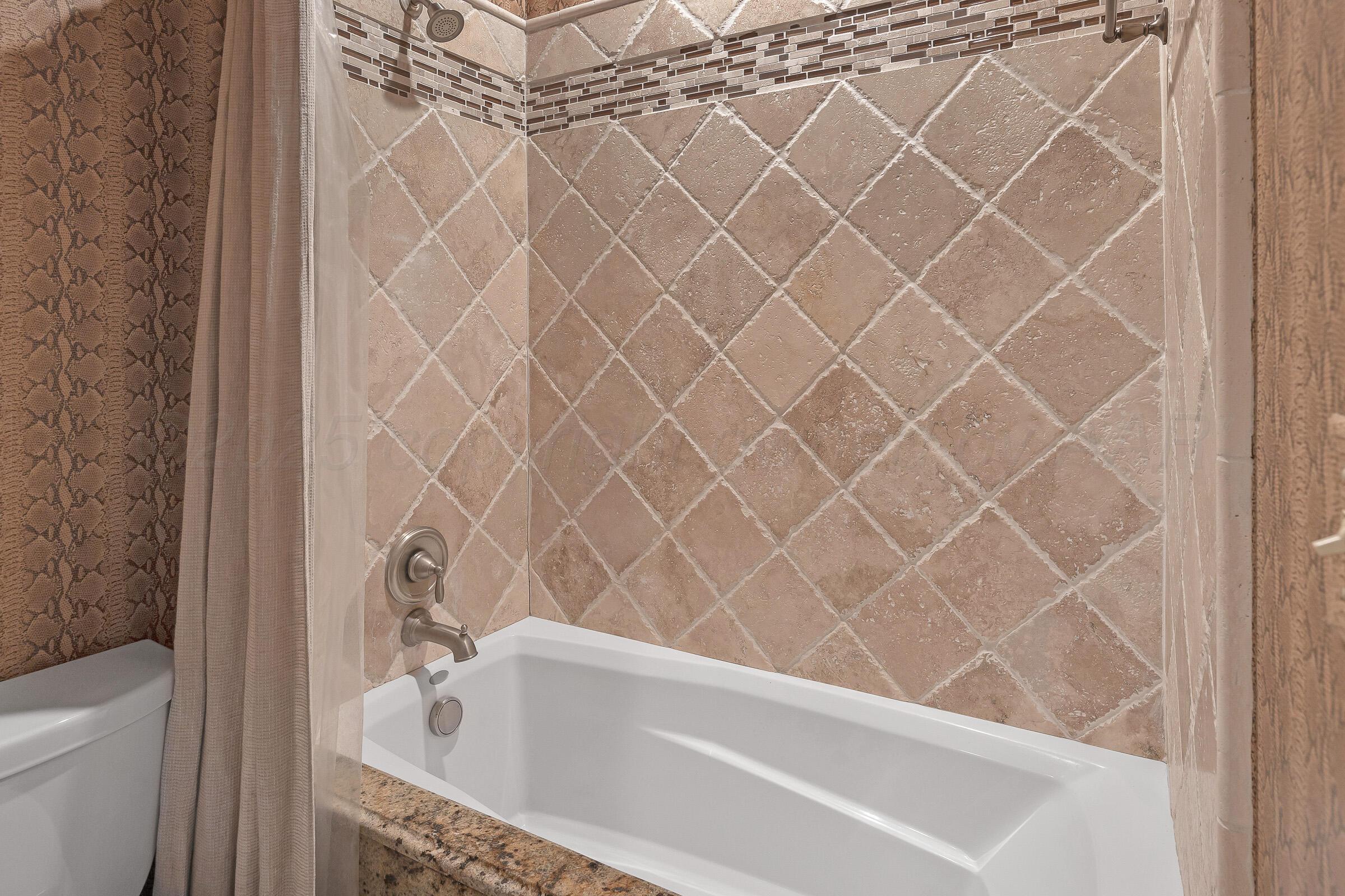 19551 Chaparral Road Canyon, TX 79015 - Photo 28 of 42 a bathroom with a bathtub and shower