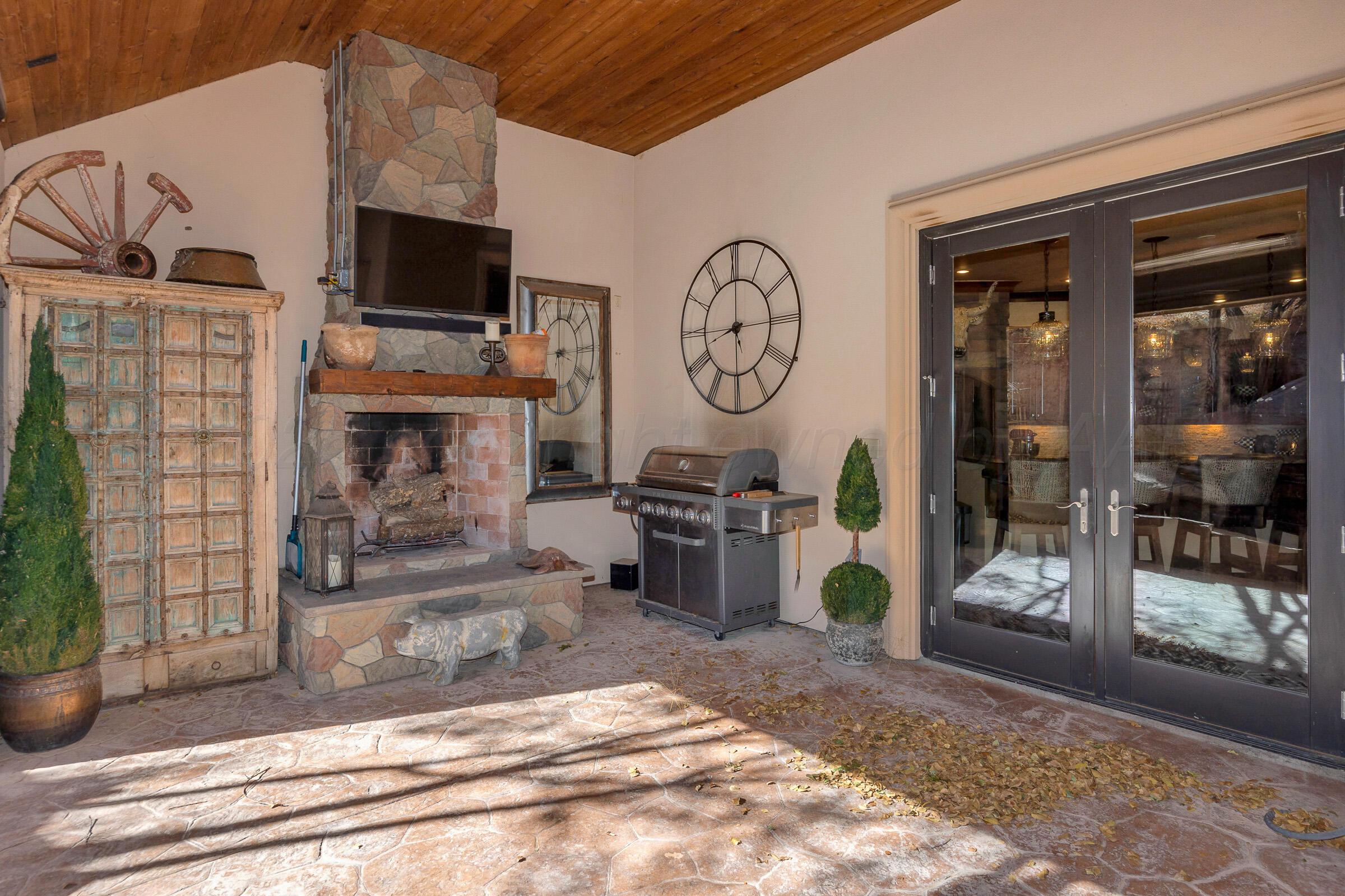 19551 Chaparral Road Canyon, TX 79015 - Photo 32 of 42 a living room with furniture a flat screen tv and a fireplace