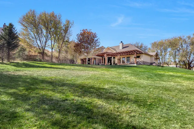 a view of a big yard with a house in the background
