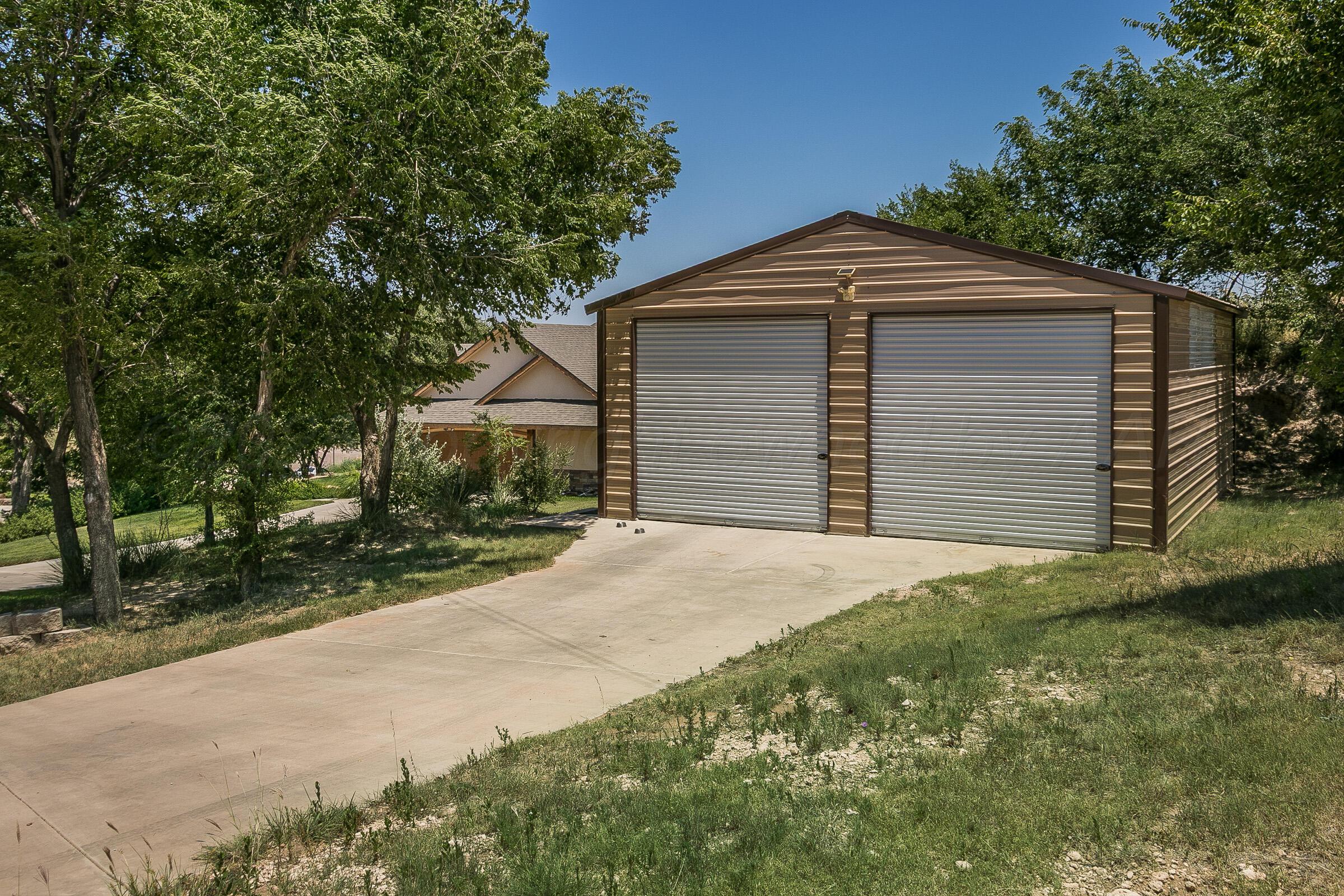 19551 Chaparral Road Canyon, TX 79015 - Photo 42 of 42 a front view of a house with a yard and garage