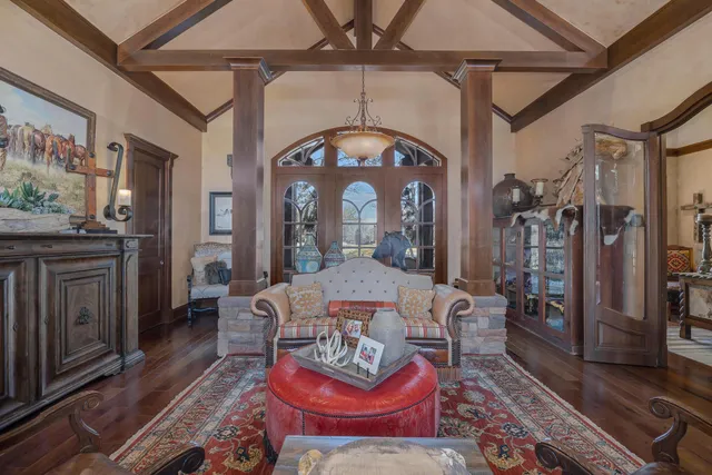 a living room with furniture a fireplace and a table