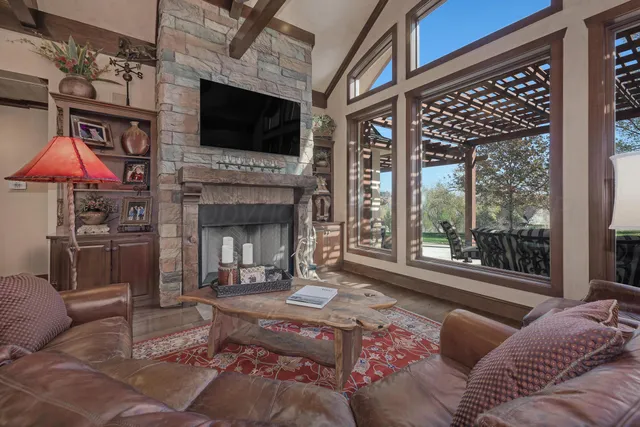 a living room with furniture a flat screen tv and a fireplace