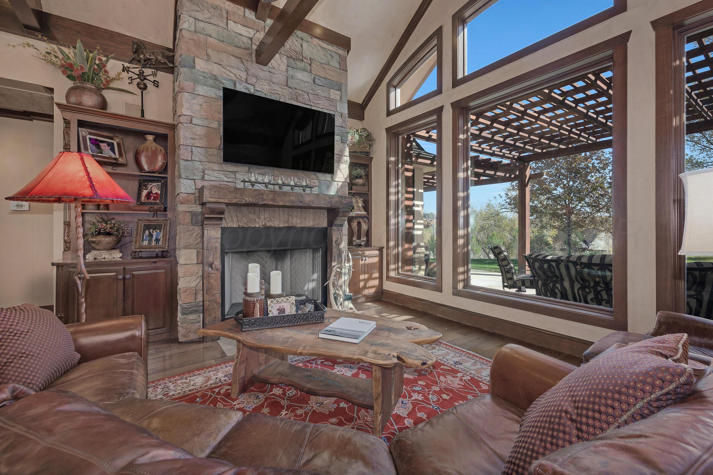 19551 Chaparral Road Canyon, TX 79015 - Photo 7 of 42 a living room with furniture a flat screen tv and a fireplace
