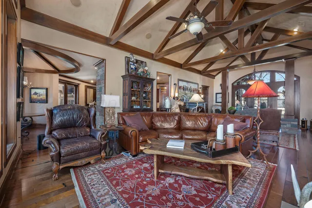 a living room with furniture and a chandelier
