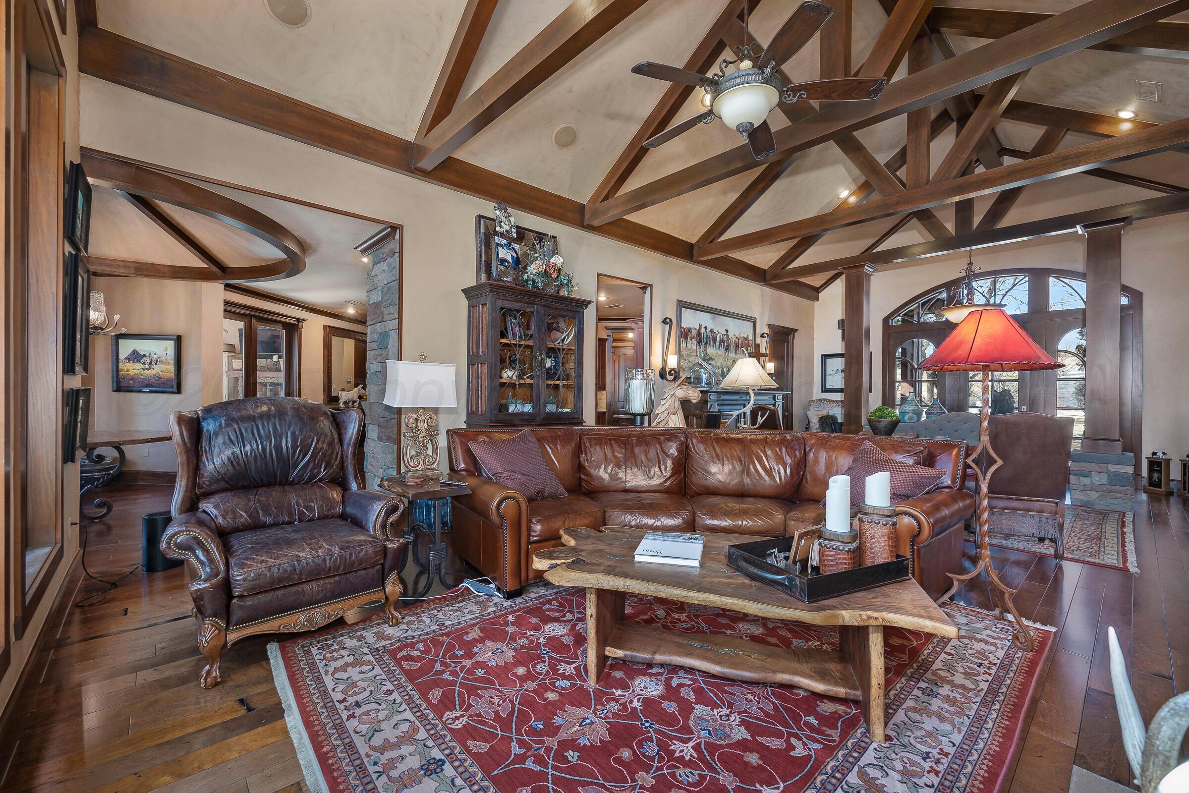 19551 Chaparral Road Canyon, TX 79015 - Photo 9 of 42 a living room with furniture and a chandelier