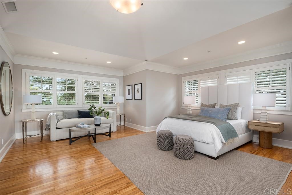 13598 Nogales Drive Del Mar, CA 92014 - Photo 13 of 21 a spacious bedroom with a bed and wooden floor