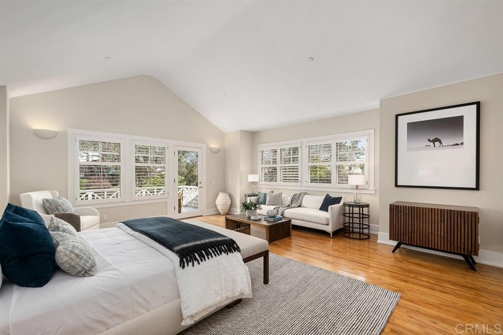 13598 Nogales Drive Del Mar, CA 92014 - Photo 17 of 21 a spacious bedroom with a bed a couch and large window