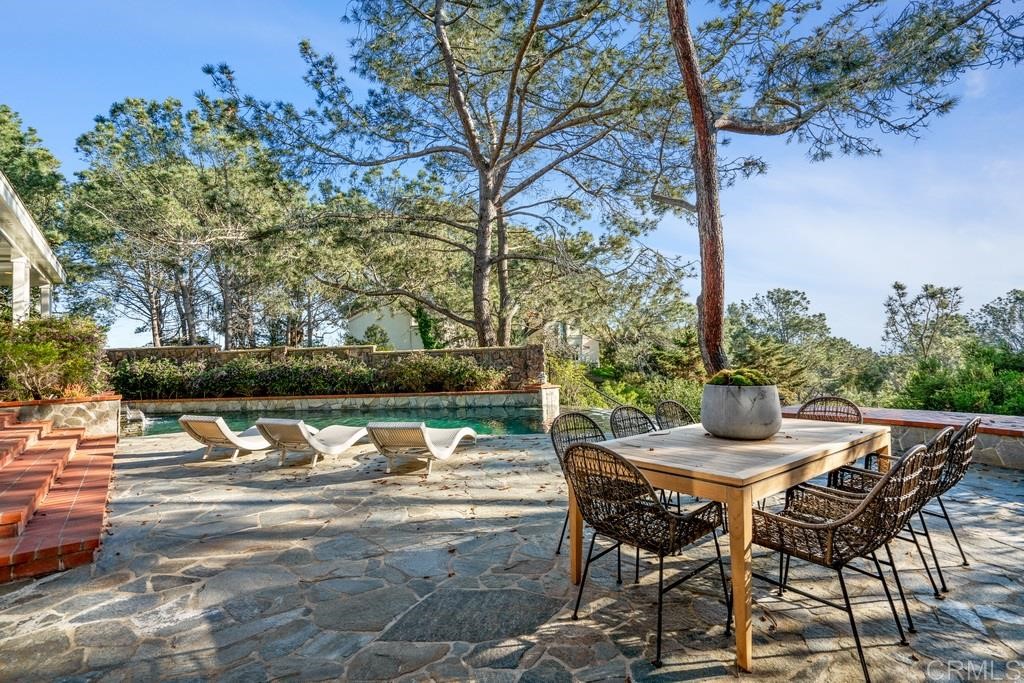 13598 Nogales Drive Del Mar, CA 92014 - Photo 20 of 21 a view of backyard with table and chairs and potted plants