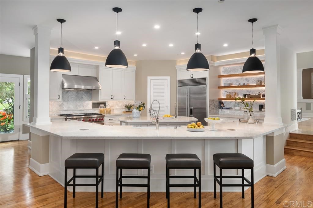 13598 Nogales Drive Del Mar, CA 92014 - Photo 8 of 21 a kitchen with granite countertop white cabinets and refrigerator
