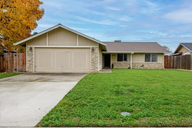 a front view of house with yard and green space
