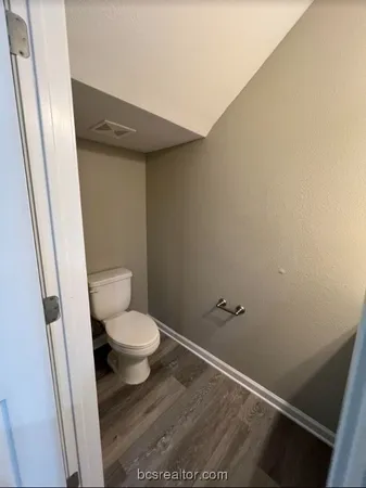 a white toilet sitting next to a shower
