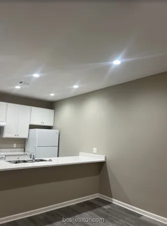 a room with a sink cabinets and utility