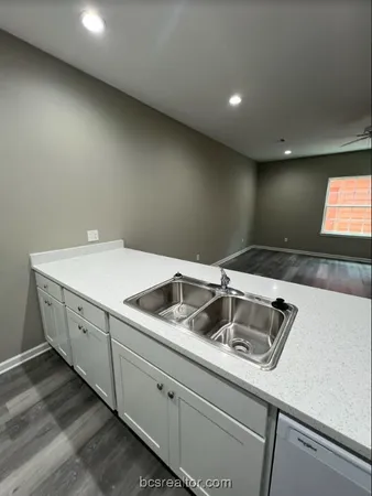 a kitchen with a sink and cabinets