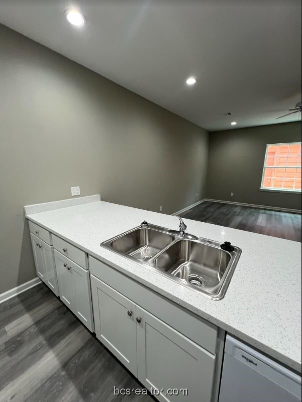 1305 West Villa Maria Road, Unit D104 Bryan, TX 77801 - Photo 9 of 13 a kitchen with a sink and cabinets