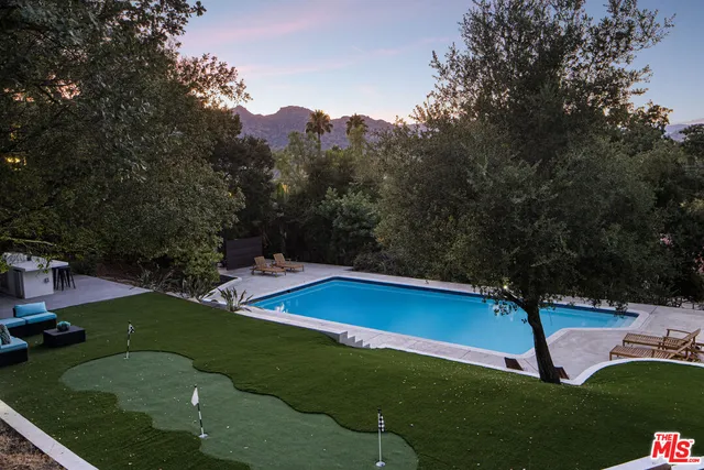 a view of a yard with wooden fence