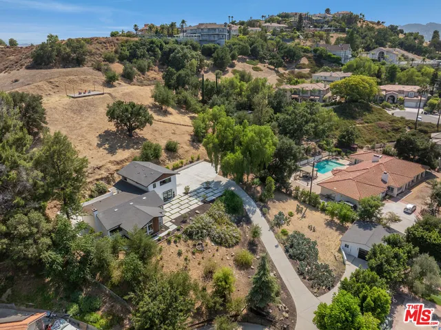 an aerial view of residential house with green space