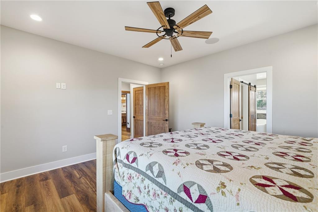 171 Hawthorne Hill Road Jasper, GA 30143 - Photo 29 of 51 a bedroom with a bed and a chandelier