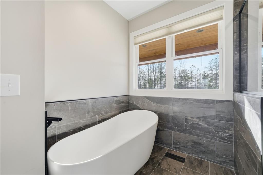 171 Hawthorne Hill Road Jasper, GA 30143 - Photo 32 of 51 a white bath tub sitting in a bathroom next to a window