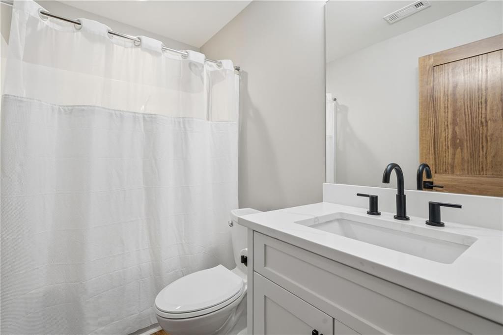 171 Hawthorne Hill Road Jasper, GA 30143 - Photo 33 of 51 a bathroom with a sink a toilet and shower