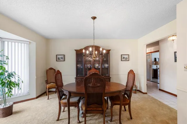 a view of a dining room with furniture and window