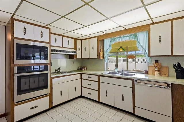 a kitchen with stainless steel appliances granite countertop a sink and cabinets