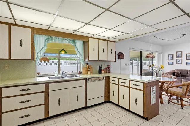 a kitchen with a sink window and cabinets