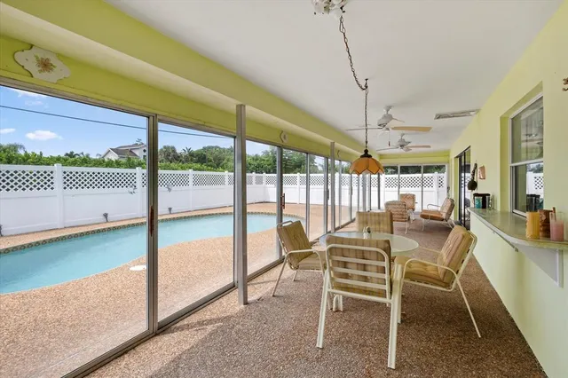 a view of a dining room with furniture wooden floor and garden view