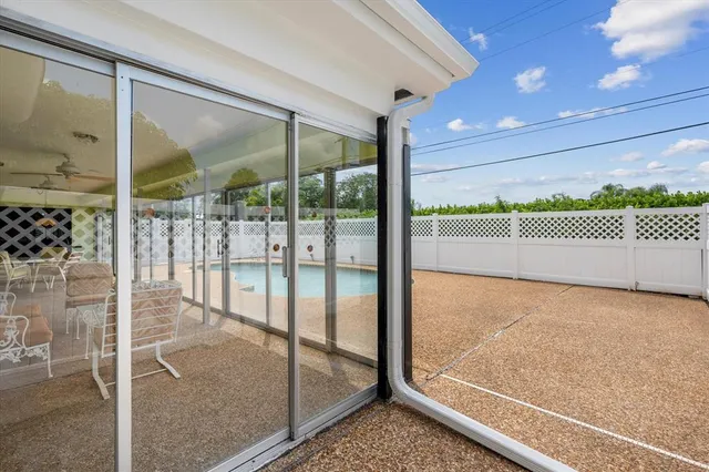a view of an empty room with floor to ceiling window